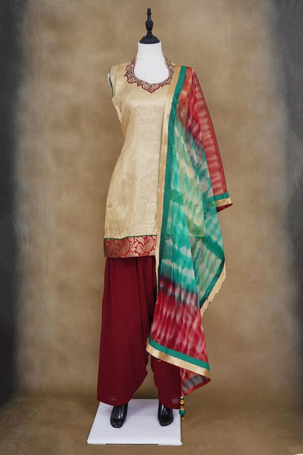 Half white floral design top with maroon palazzo bottom and red and green shawl kurti