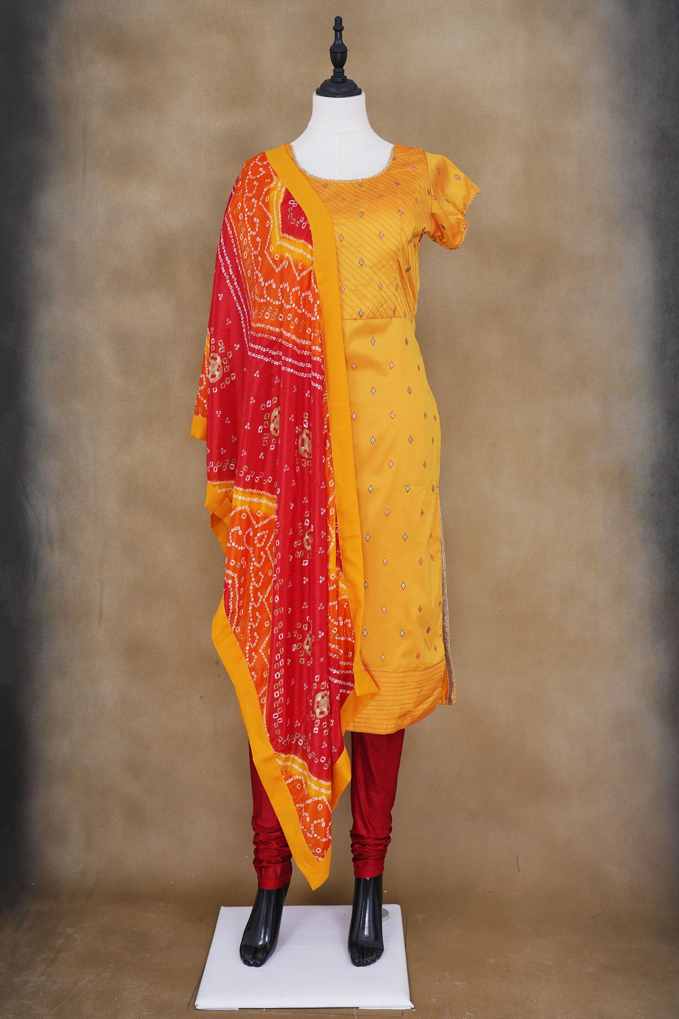 Yellow top with red bottom and red shawl kurti